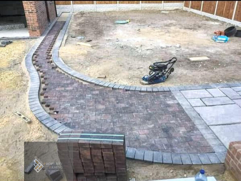 Block paving installation with levels set before surface completion